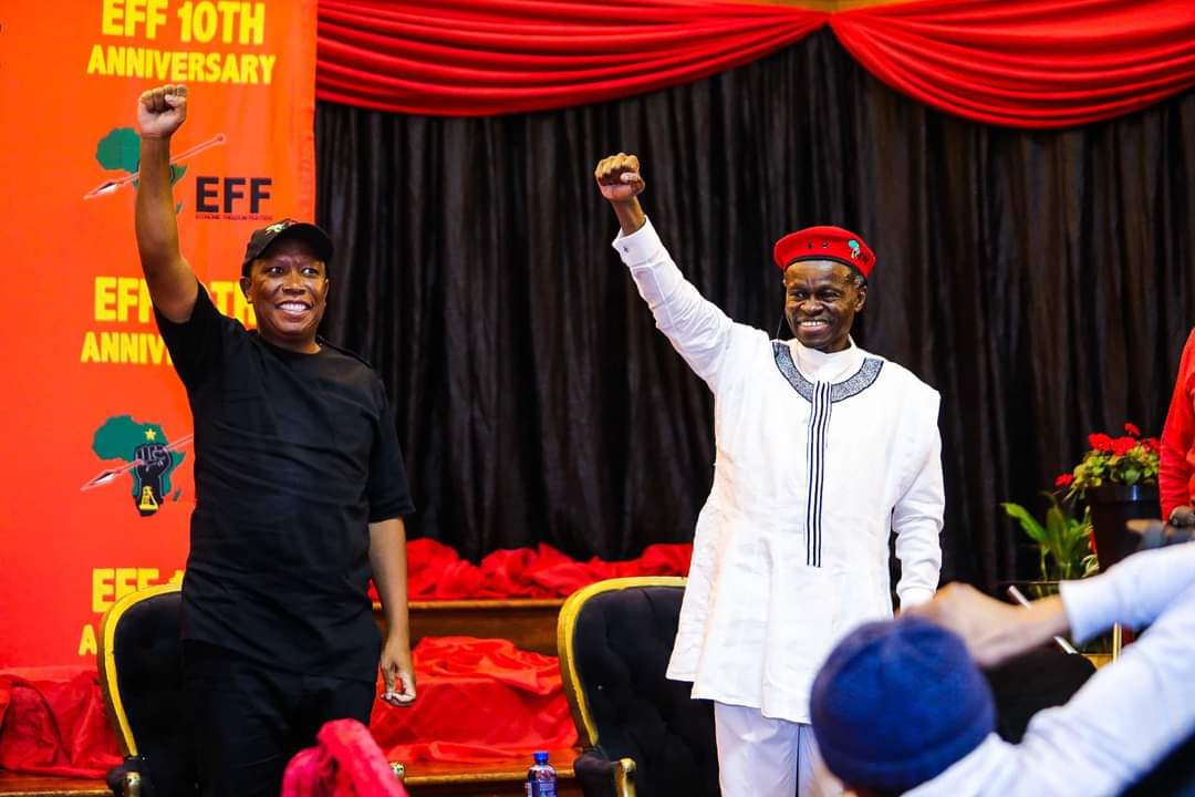 PLO Lumumba and Julius Malema raising their fists at the EFF tenth-anniversary lecture